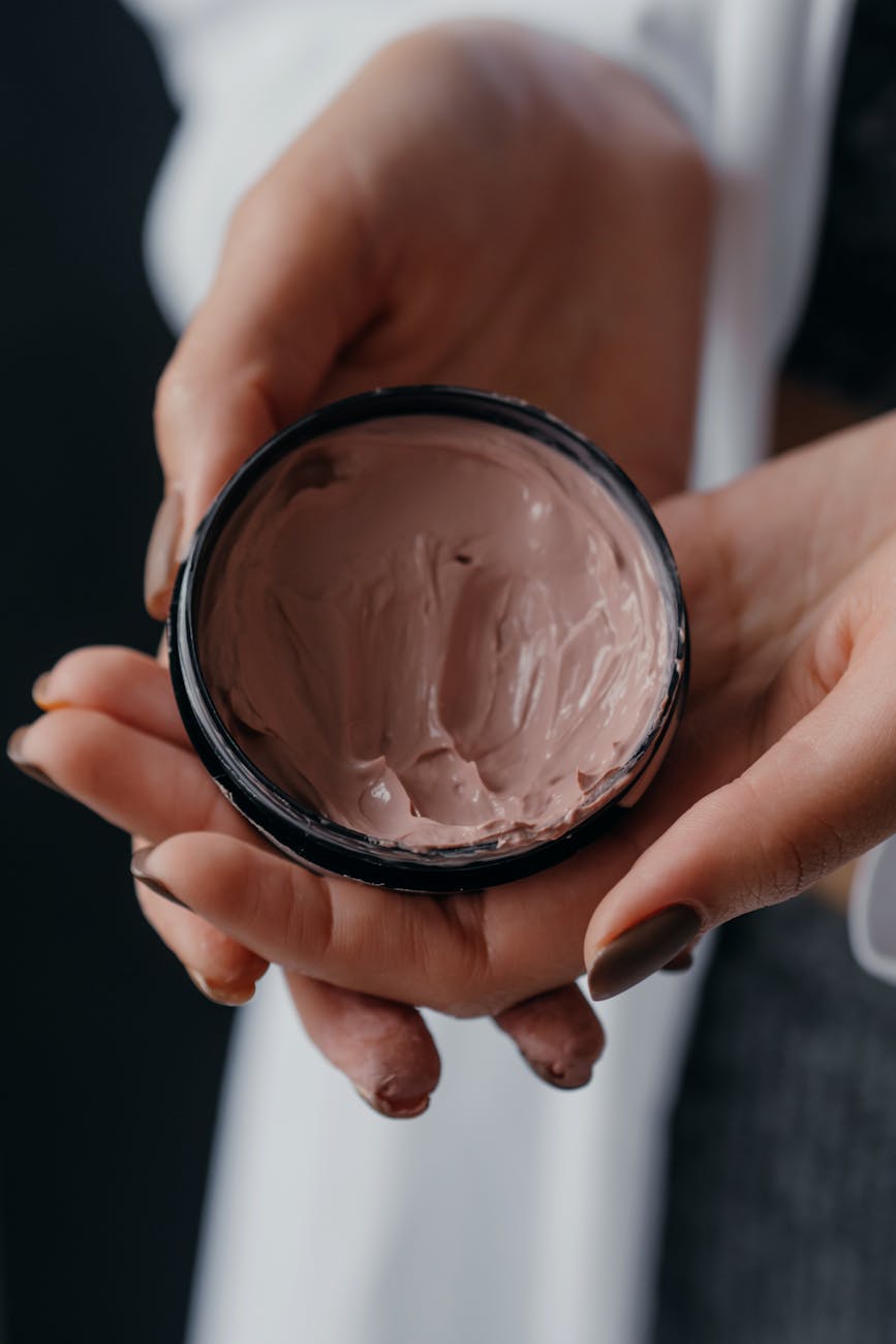 close up photo of a person holding a skin care product